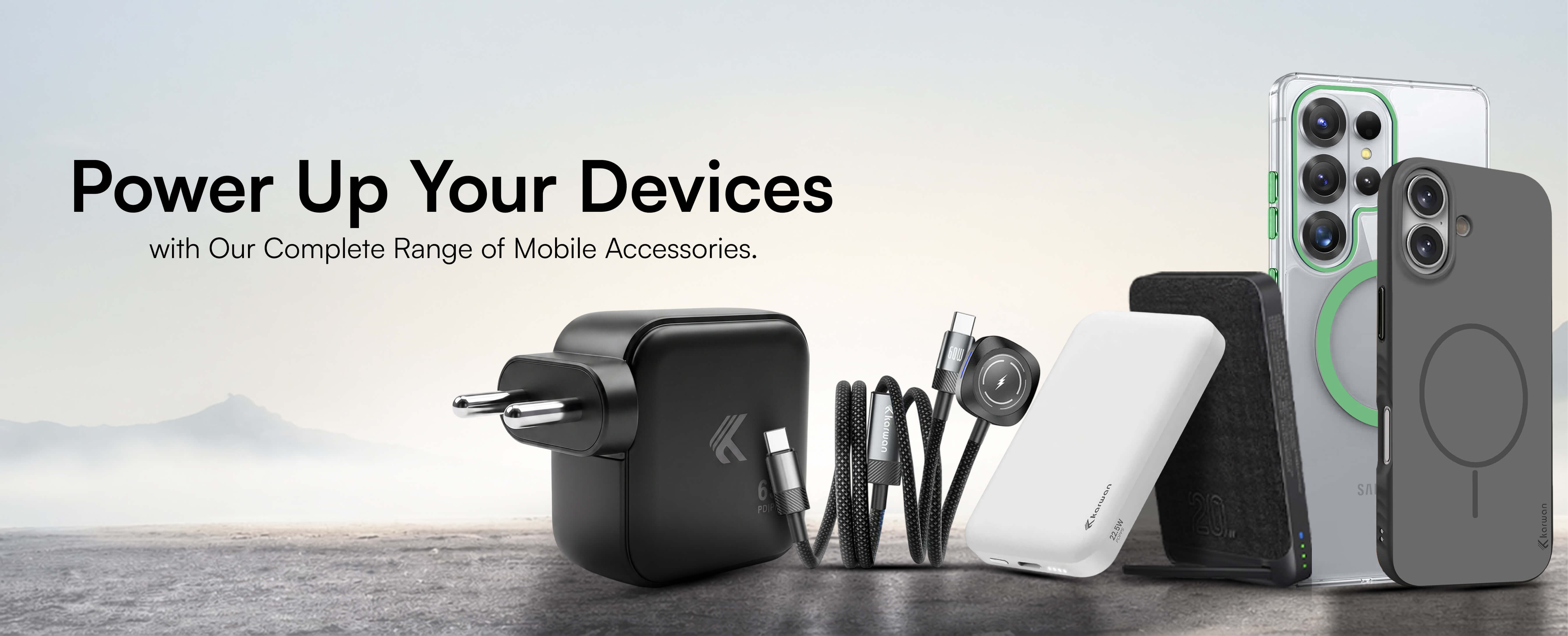 karwan Collection of mobile accessories including a phone, charger, and stand on a wooden surface with a scenic background.